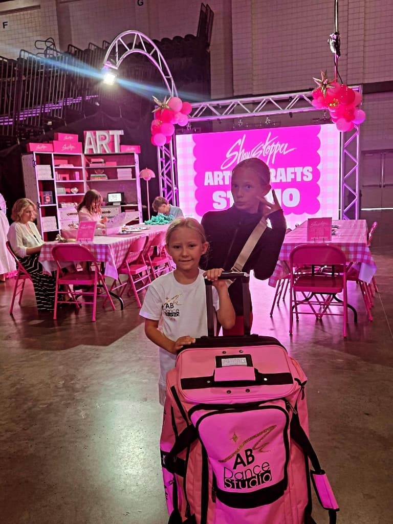 Young dancers with an AB Dance Studio travel bag at a Showstopper competition